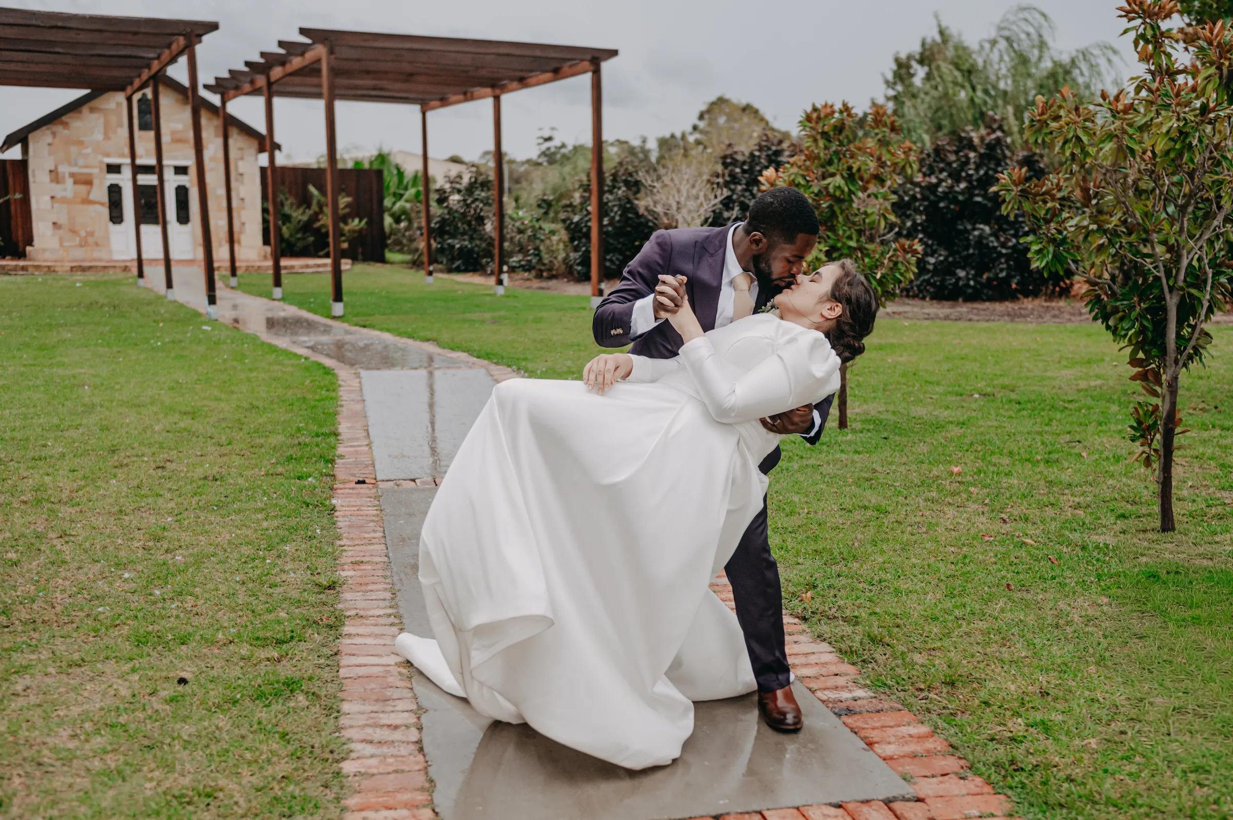 Jonathan dipping Cassandra for a kiss on the lawn at Chapel Farm Estate