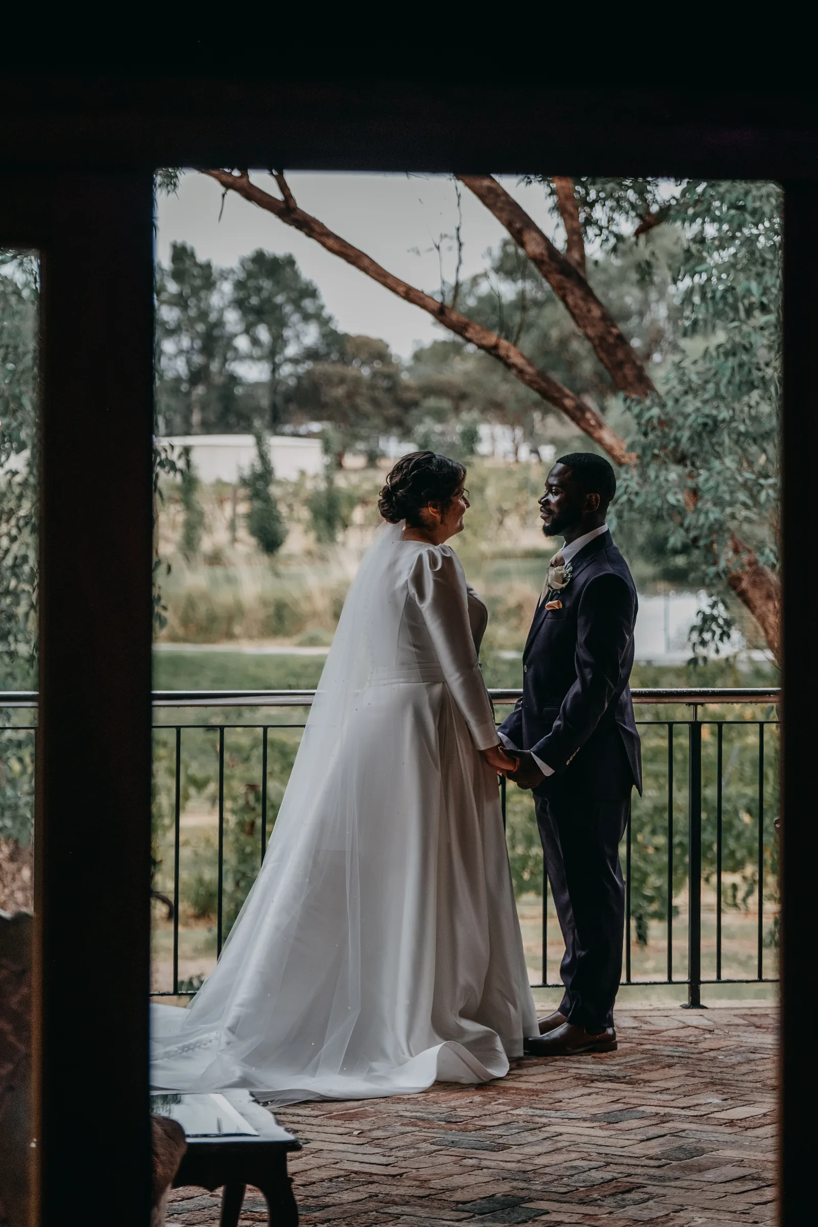 Cassandra and Jonathan sharing a private moment in a stone doorway at Chapel Farm Estate before the ceremony
