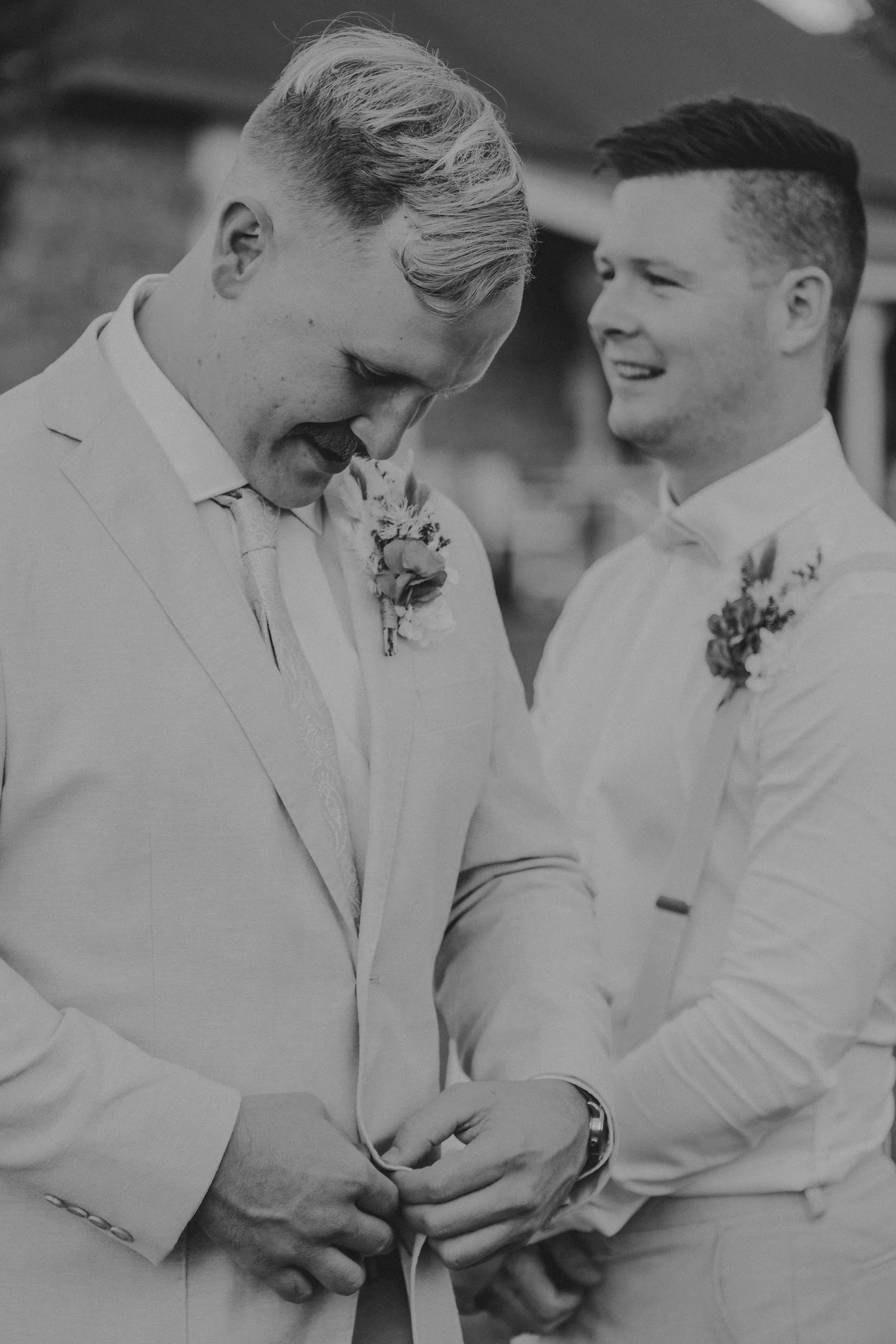 Black and white photograph of Lachie sharing an emotional moment with a groomsman before the ceremony at Buckland Estate