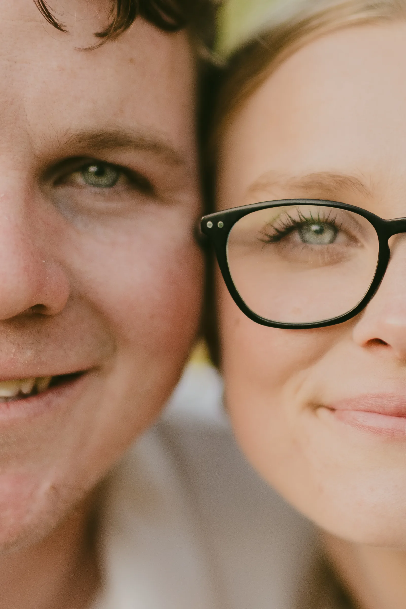 Close-up portrait of Kayla and Brett cheek to cheek, both smiling at the camera at Kings Park