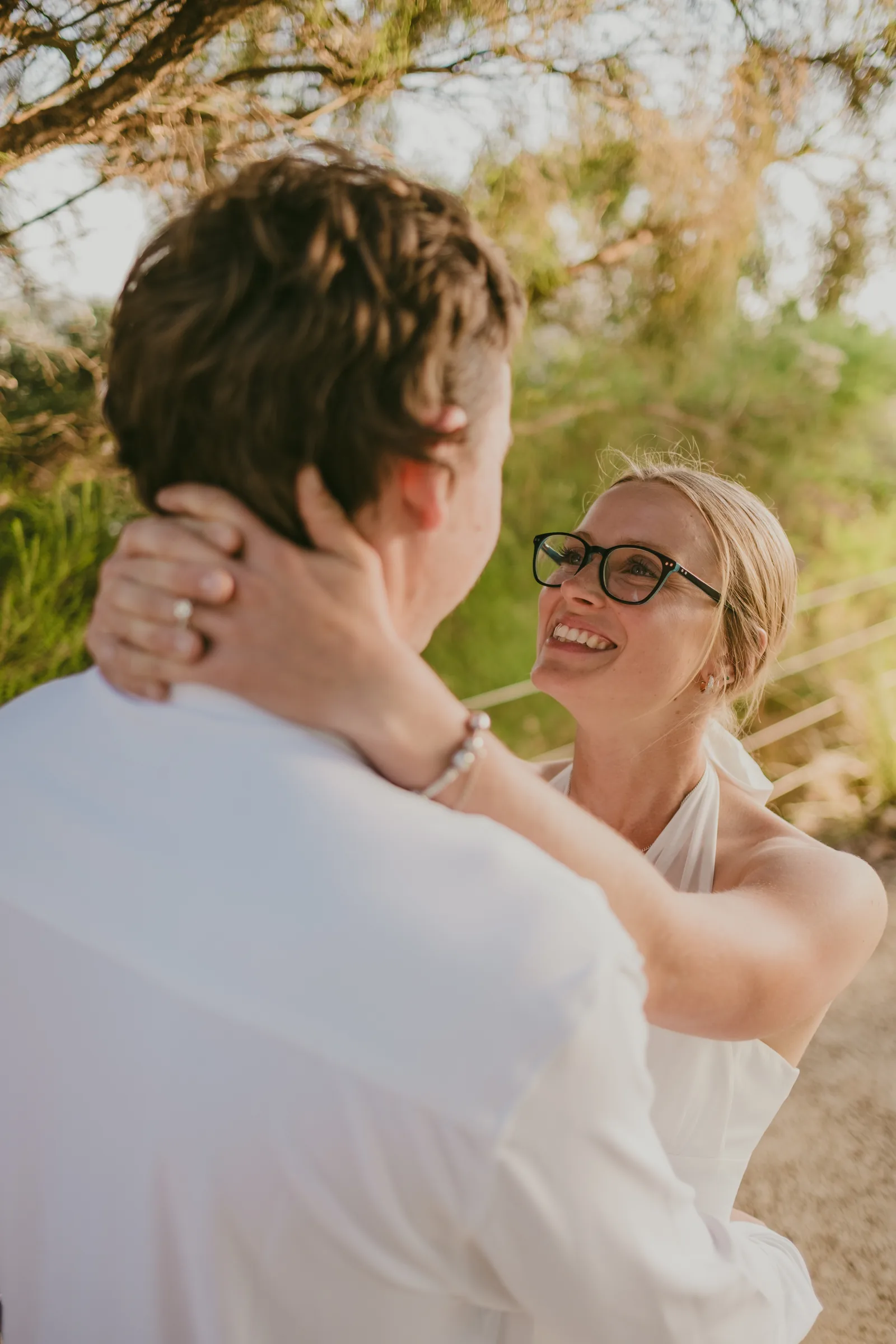 Kayla and Brett embracing on the lawn at Kings Park during golden hour