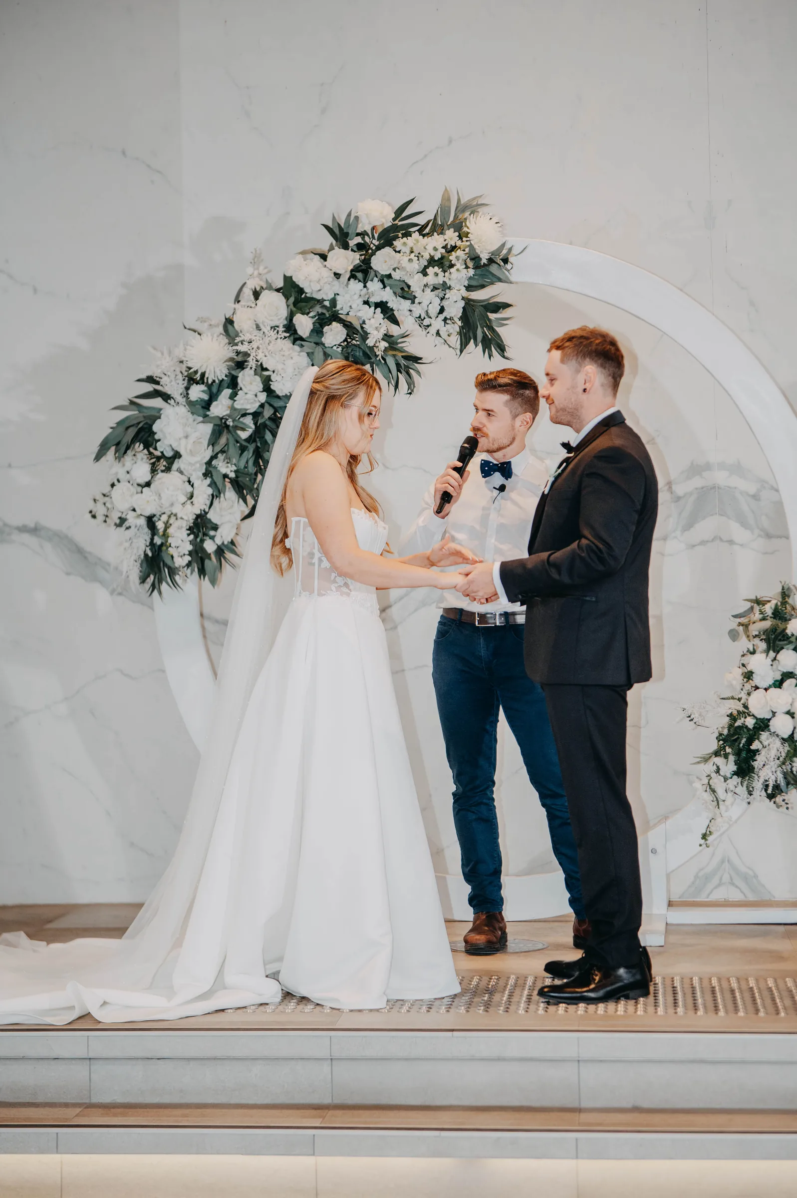 Close-up of Kirra and Mitch exchanging rings during their Garden Pavilion ceremony