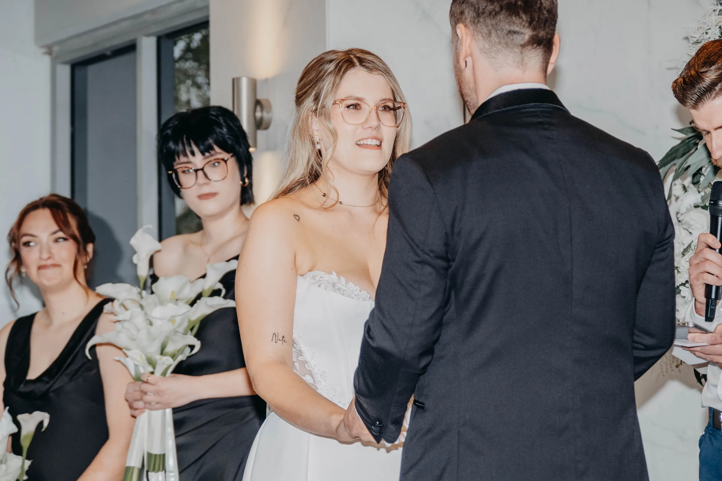 A bridesmaid passing flowers to Kirra during the Garden Pavilion ceremony at The Vines Resort