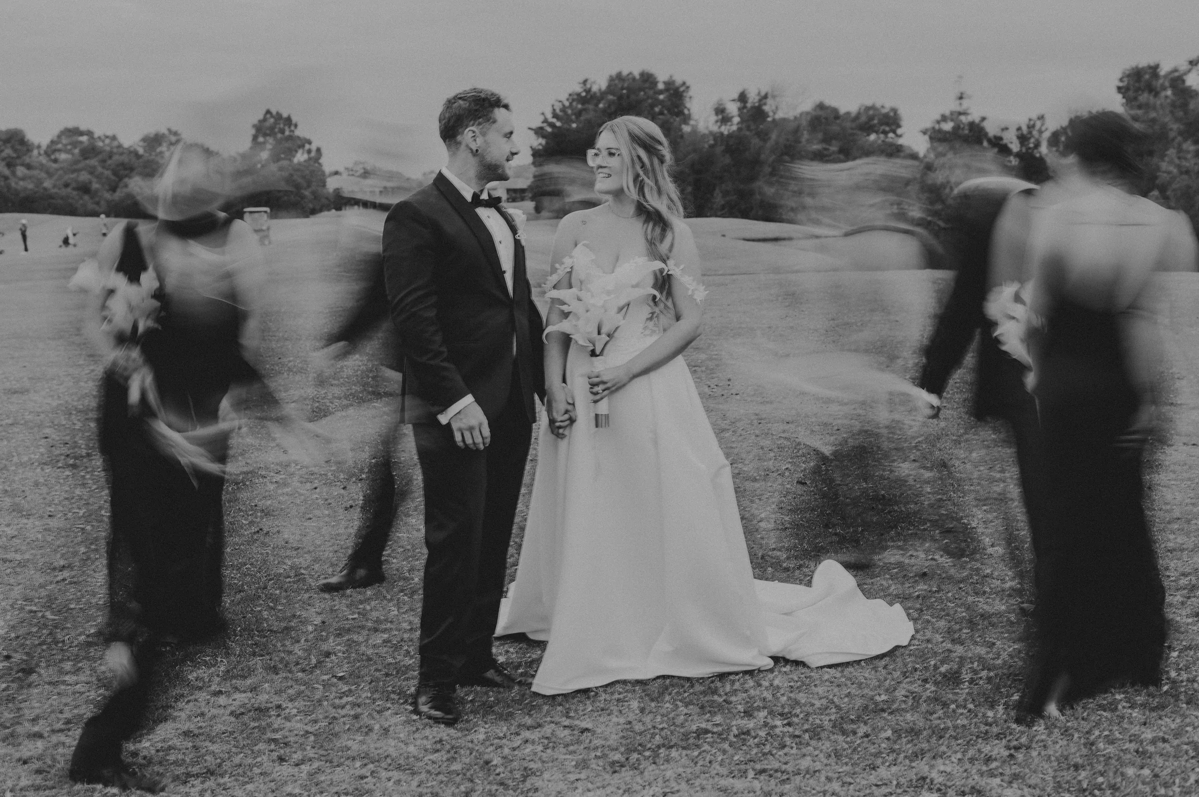 Kirra and Mitch's wedding party riding golf carts across The Vines Resort grounds
