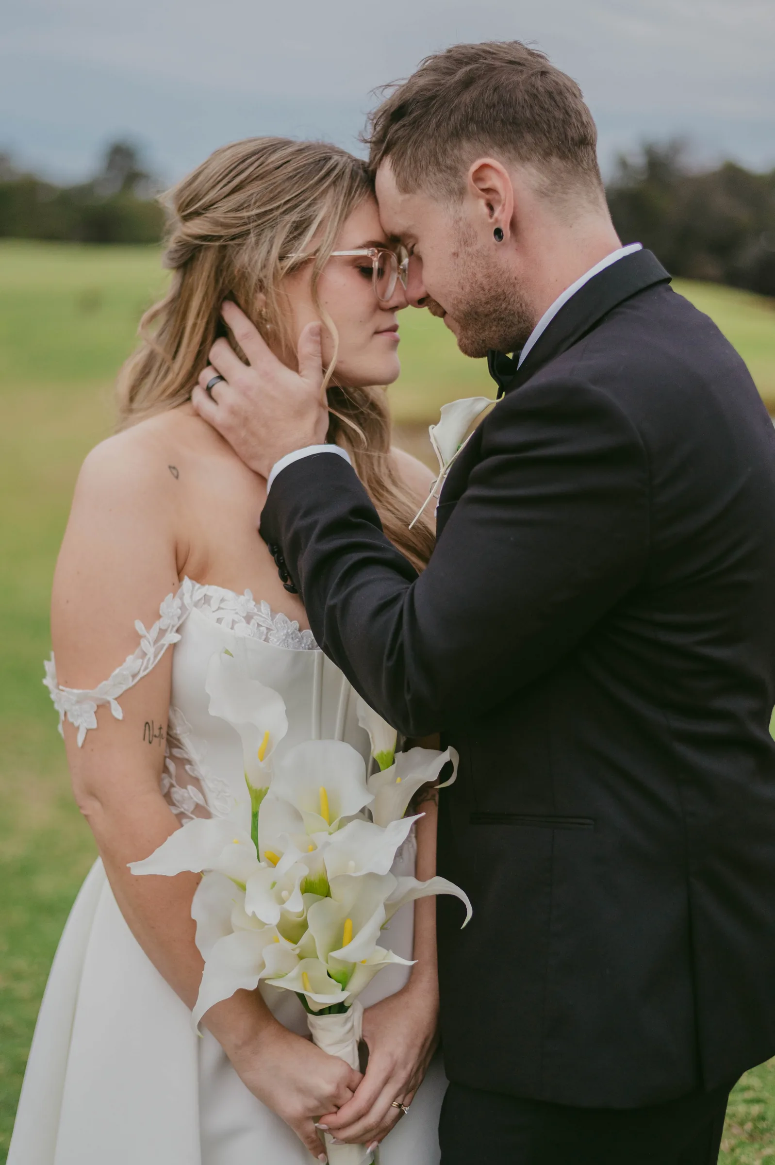Kirra and Mitch holding hands together at dusk on The Vines Resort grounds
