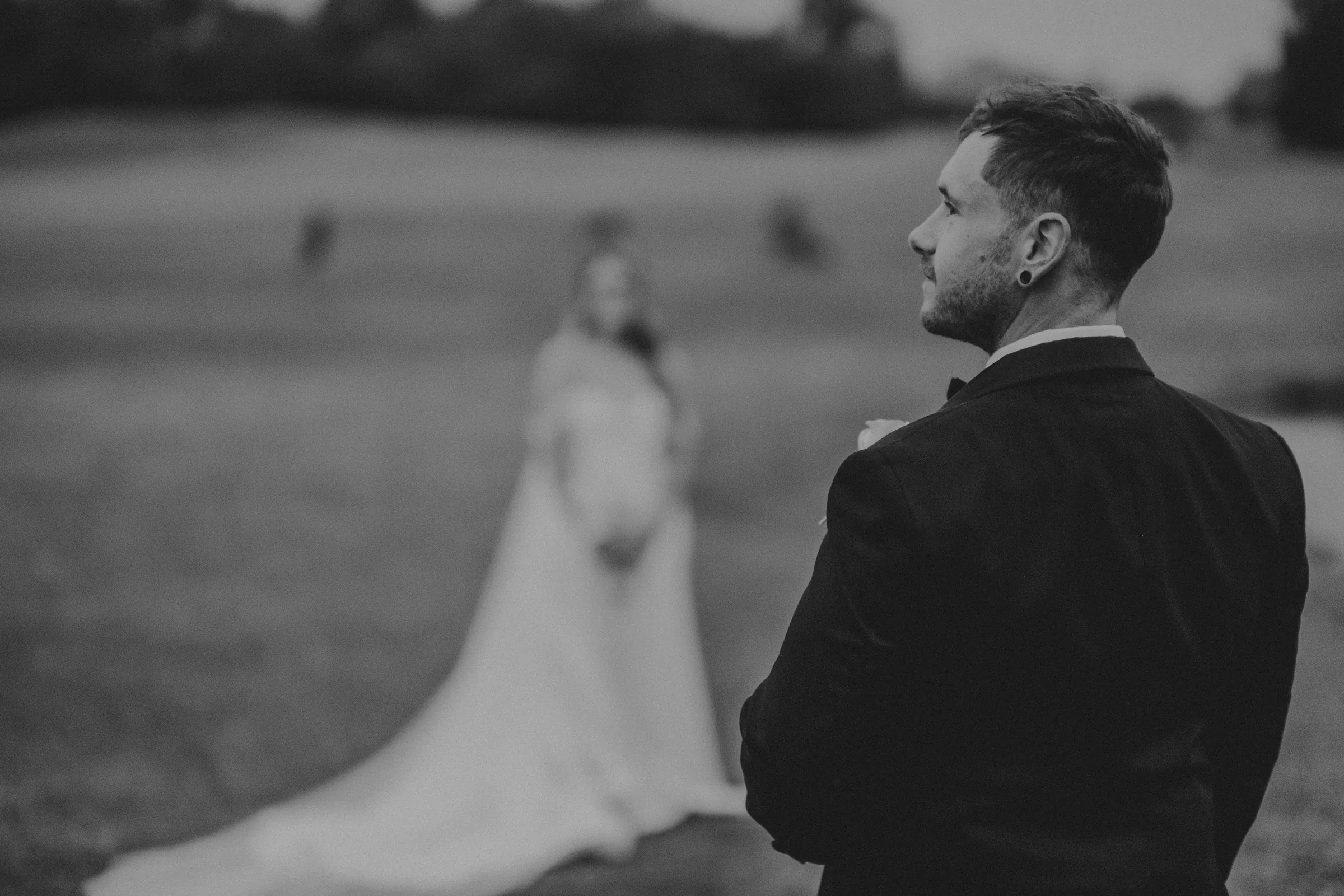 Black and white silhouette of Kirra and Mitch against The Vines Resort skyline at dusk