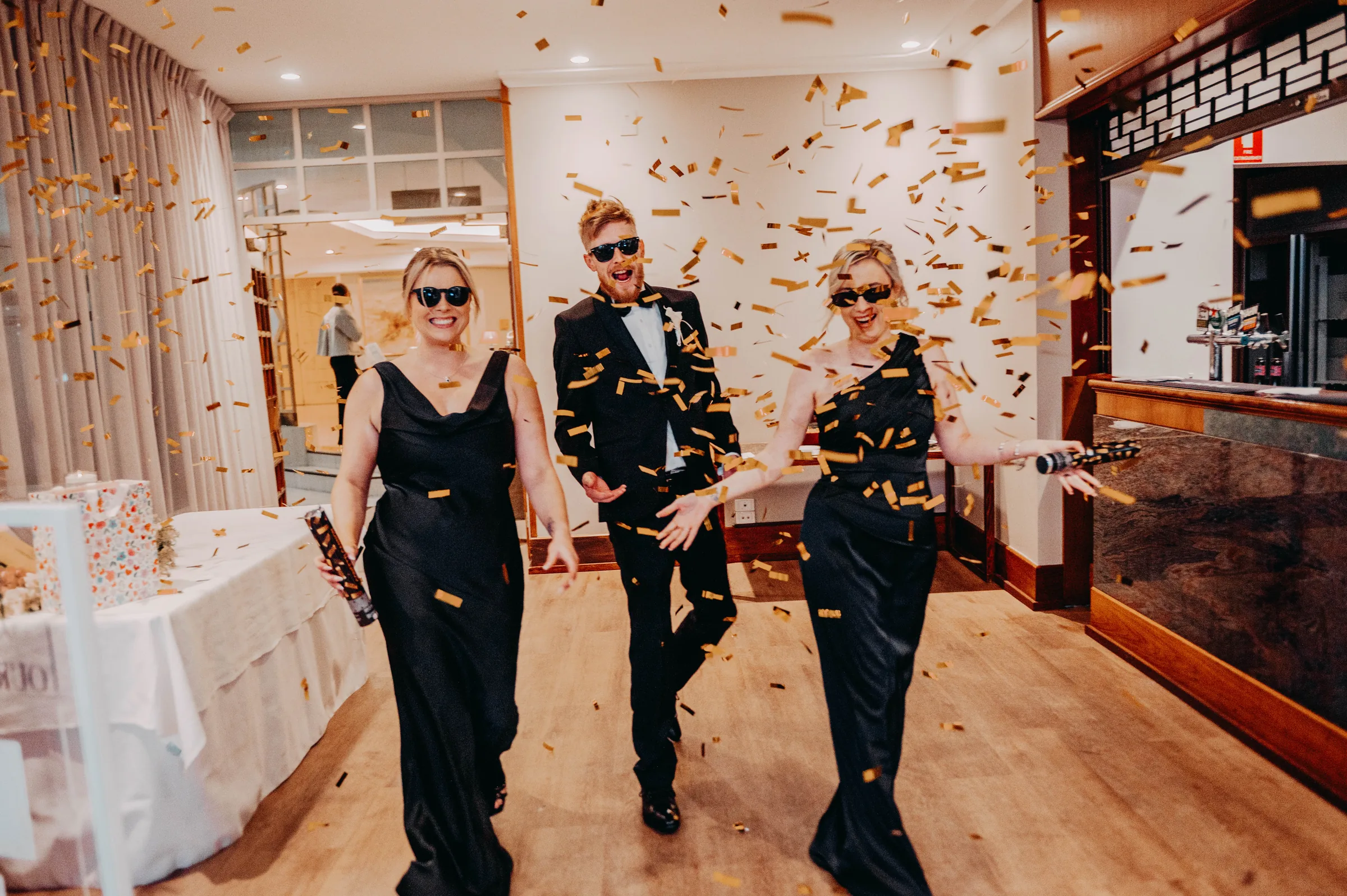 Wedding party walking through confetti at Kirra and Mitch's reception, The Vines Resort