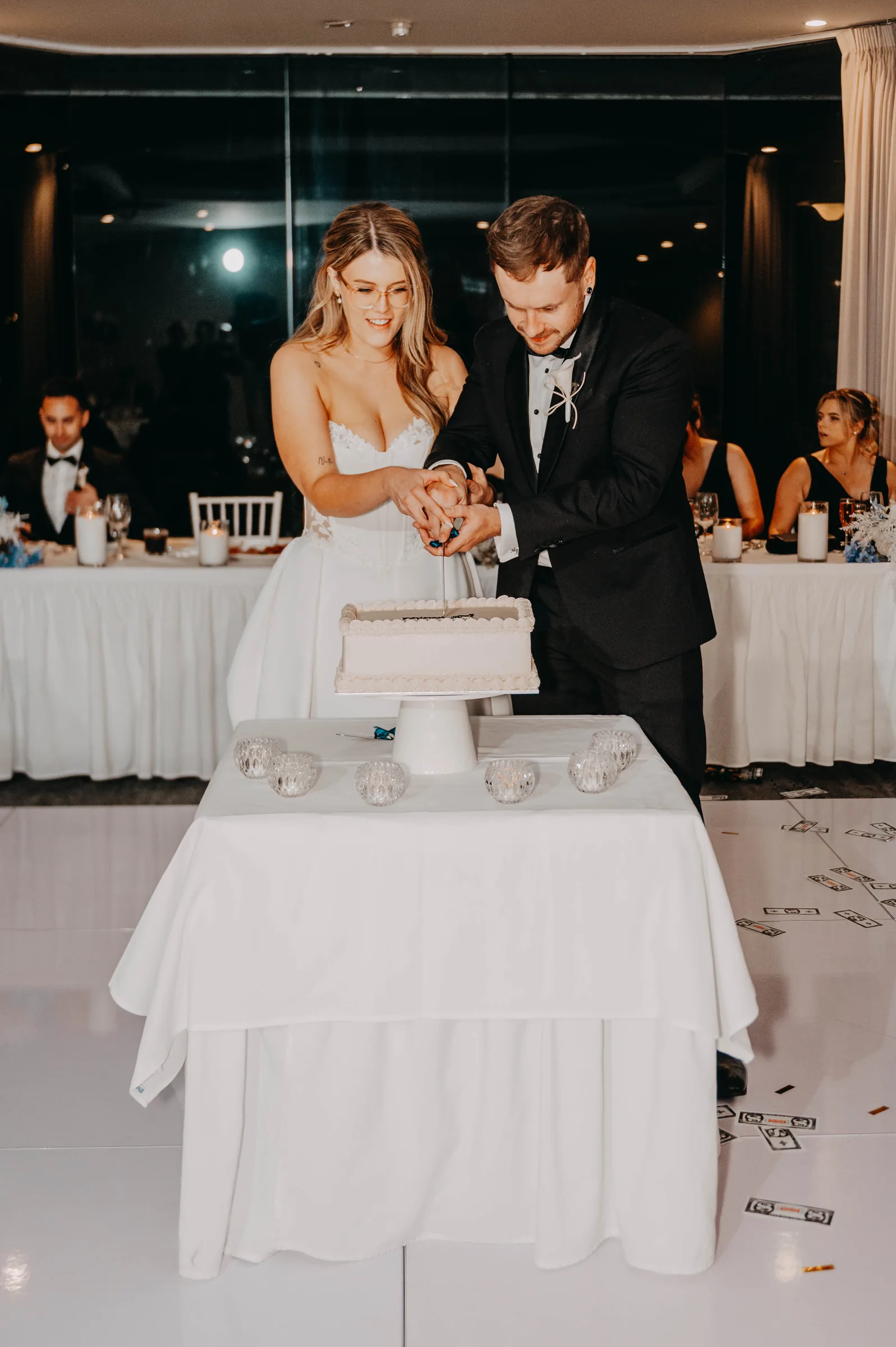 Kirra and Mitch cutting their wedding cake together at The Vines Resort reception