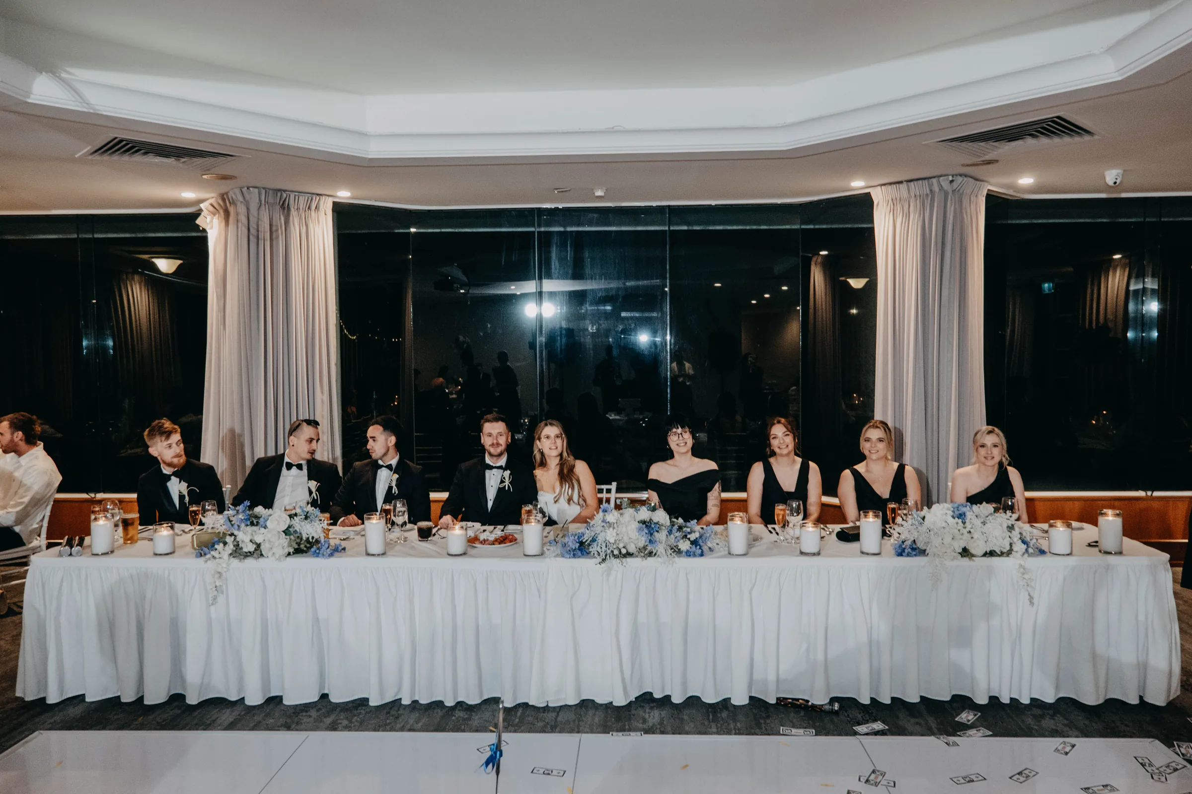 Wide view of the bridal party head table set up for Kirra and Mitch's Vines Resort reception