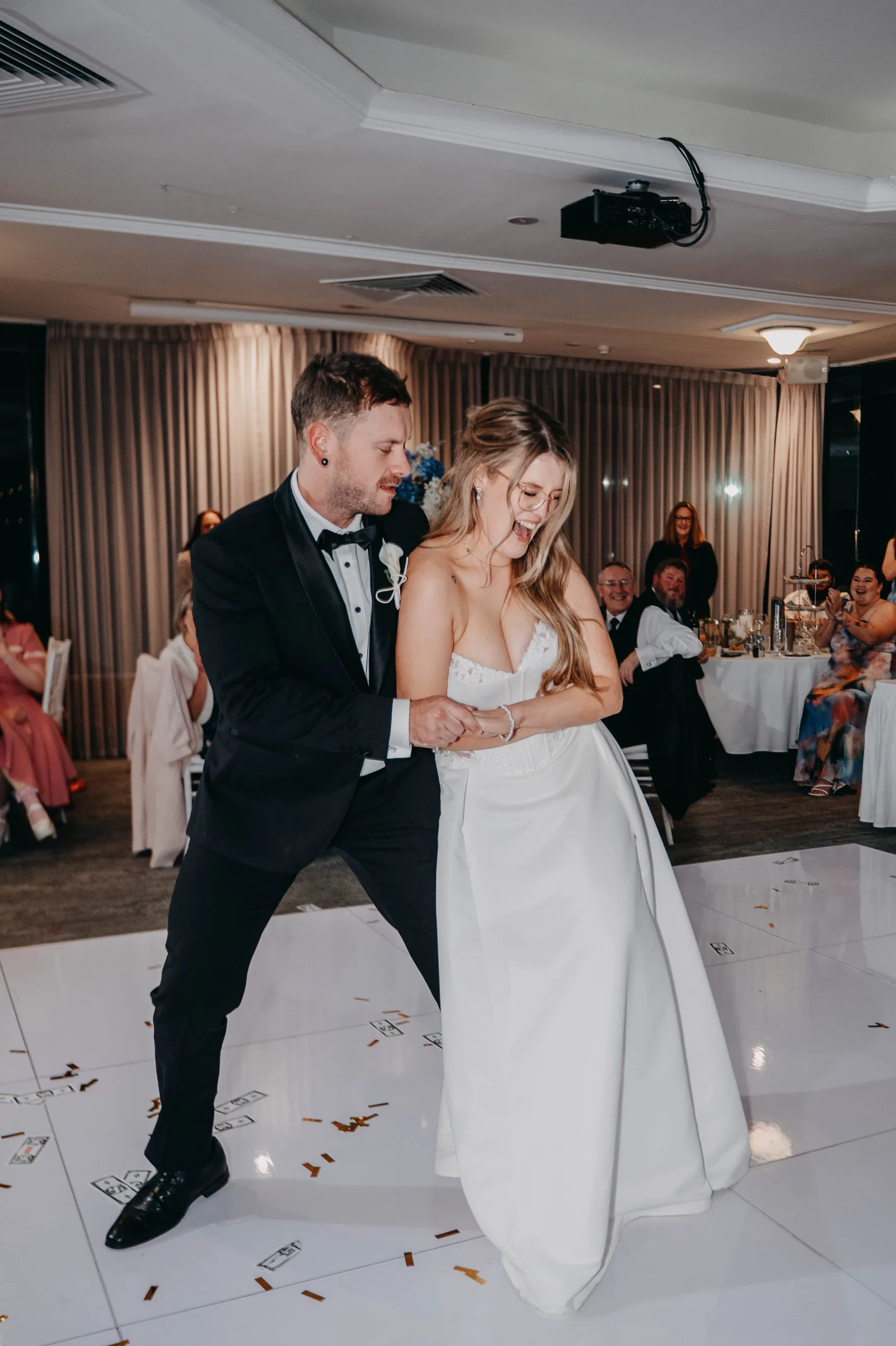 Kirra and Mitch dancing playfully together at their Vines Resort wedding reception