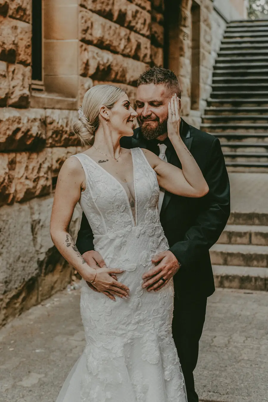 Chantelle and Zach walking hand in hand into the heritage building doorway, Perth wedding