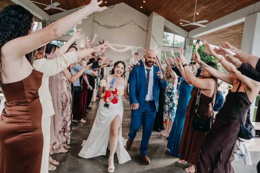 Kerry and Richard's wedding ceremony exit under raised hands at The Vines Resort, Perth