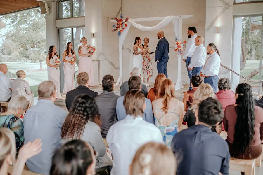 Wide view of Kerry and Richard's ceremony with guests seated under the pavilion