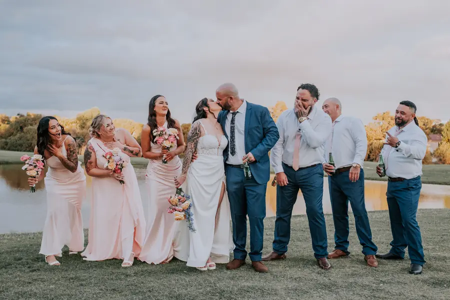 Bridal party celebrating with the newlyweds on the golf course at The Vines Resort
