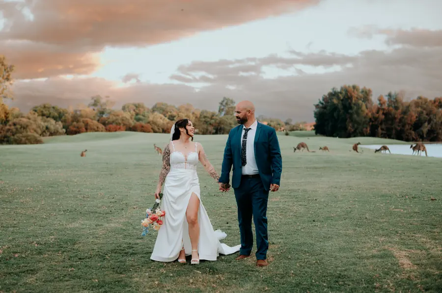 Kerry and Richard laughing together on the fairway at The Vines Resort at dusk