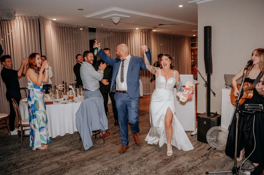 Kerry and Richard dancing arm in arm as a live band plays at their reception