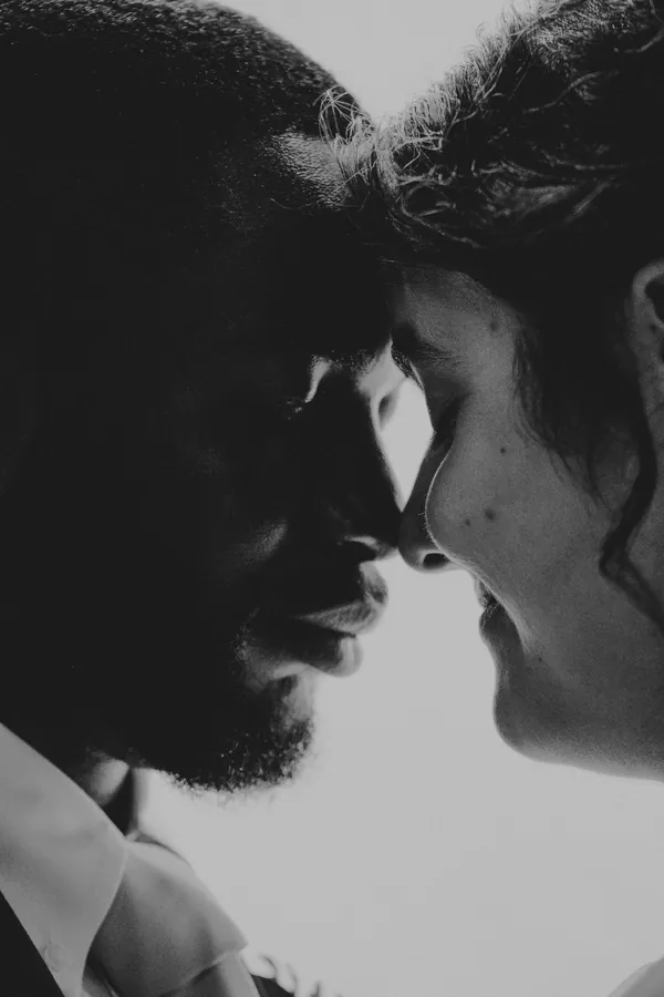 Black and white close-up of Cassandra and Jonathan nose to nose after the ceremony