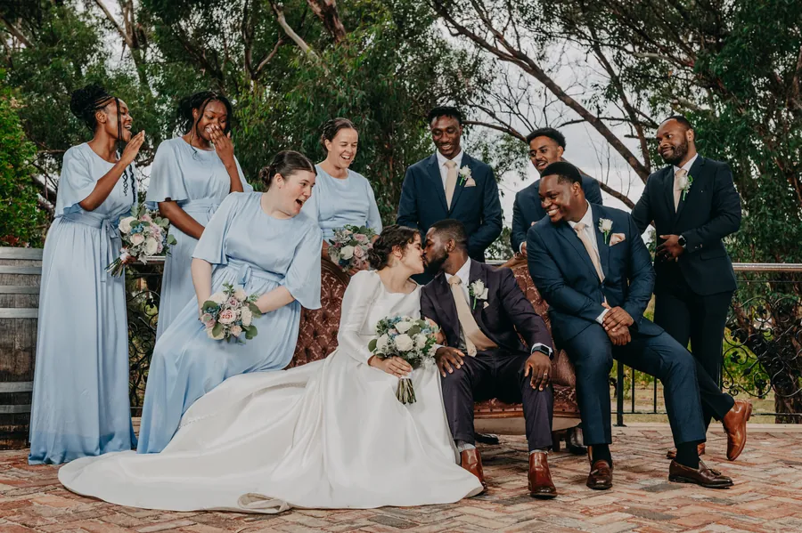 The full wedding party gathered on the deck at Chapel Farm Estate after the ceremony