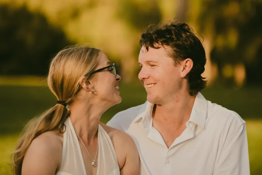 Kayla and Brett laughing together up close in golden light at Kings Park