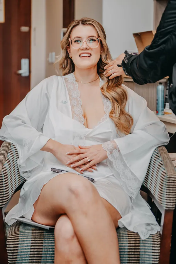 Kirra sitting in her robe before her wedding, portrait taken at The Vines Resort