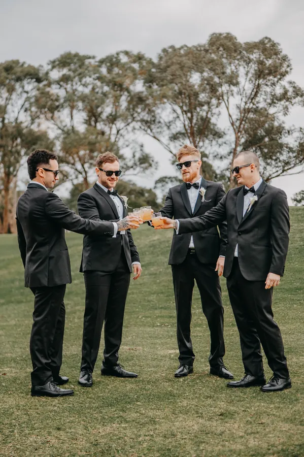 Mitch and his groomsmen huddled together in a circle before the ceremony at The Vines Resort