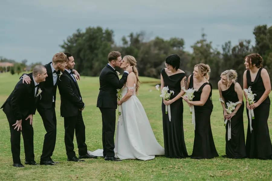 Kirra and Mitch looking at each other, full-length portrait on The Vines Resort fairway